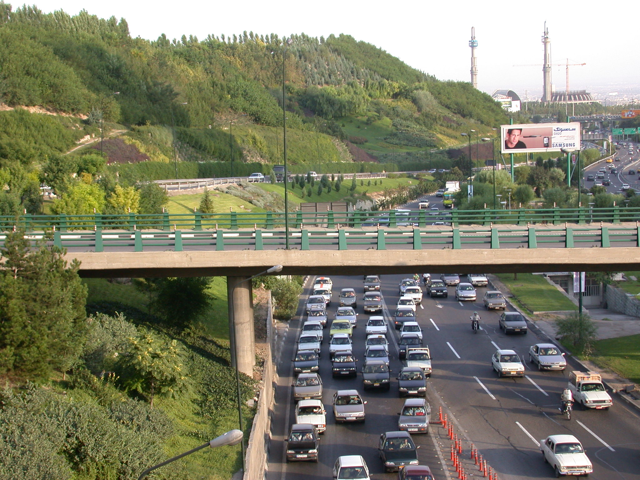 Urban landscape of Modarres Highway in Tehran, showcasing the central section with city infrastructure and greenery, captured in 1999.